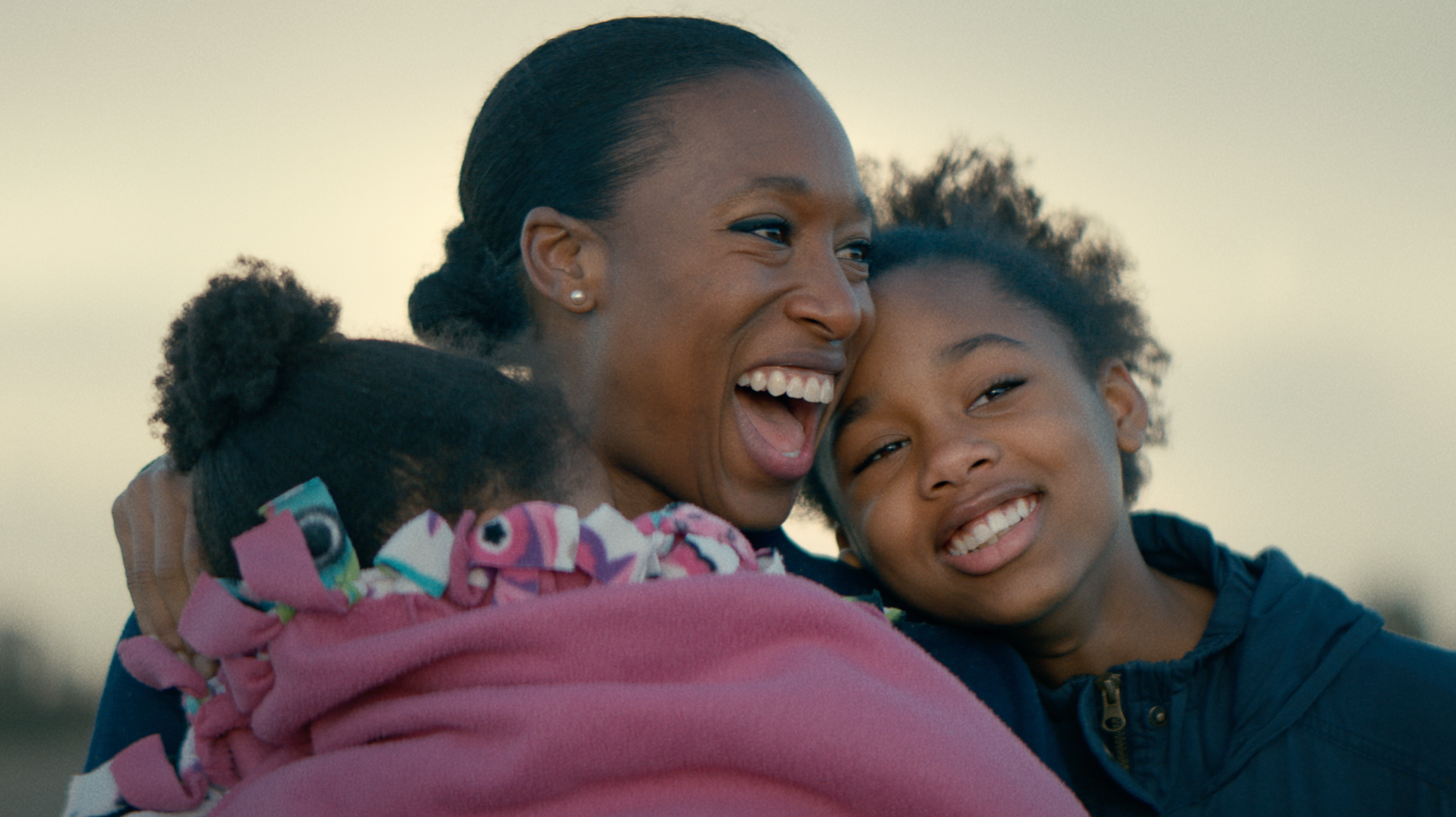 Mom hugging two children