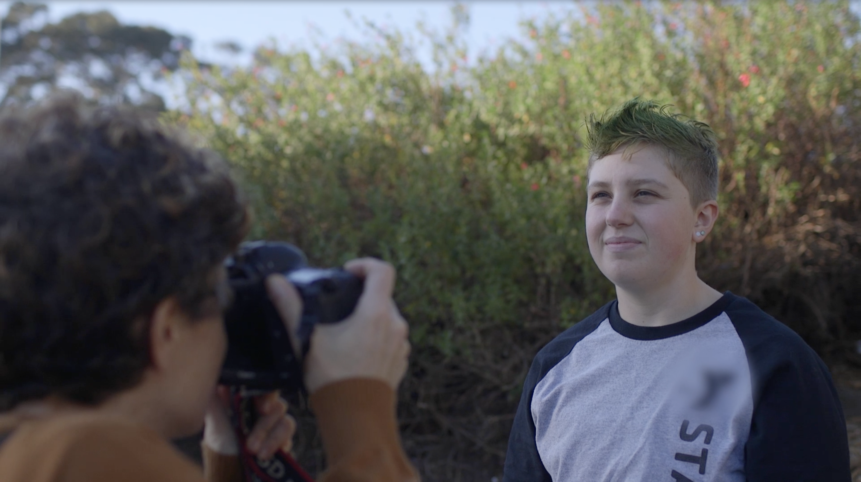 photographer taking photo of trans teen