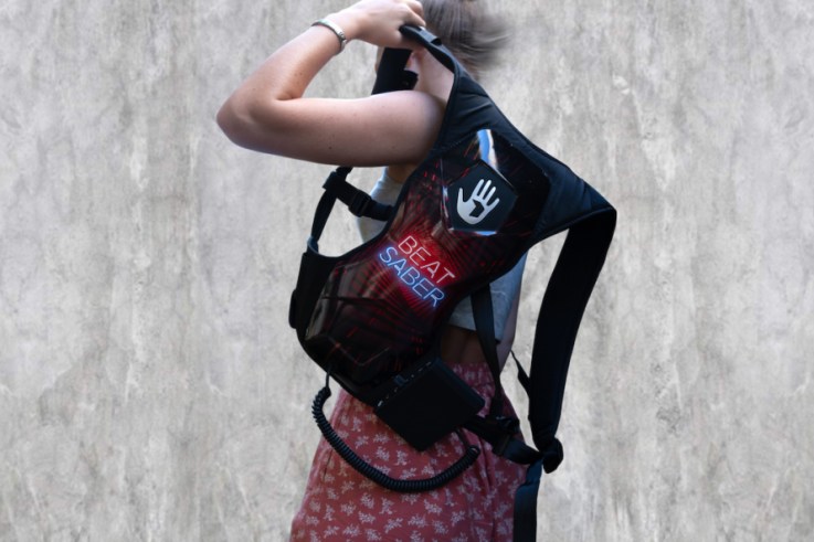 Photo of woman wearing a Beat Saber SUBPAC