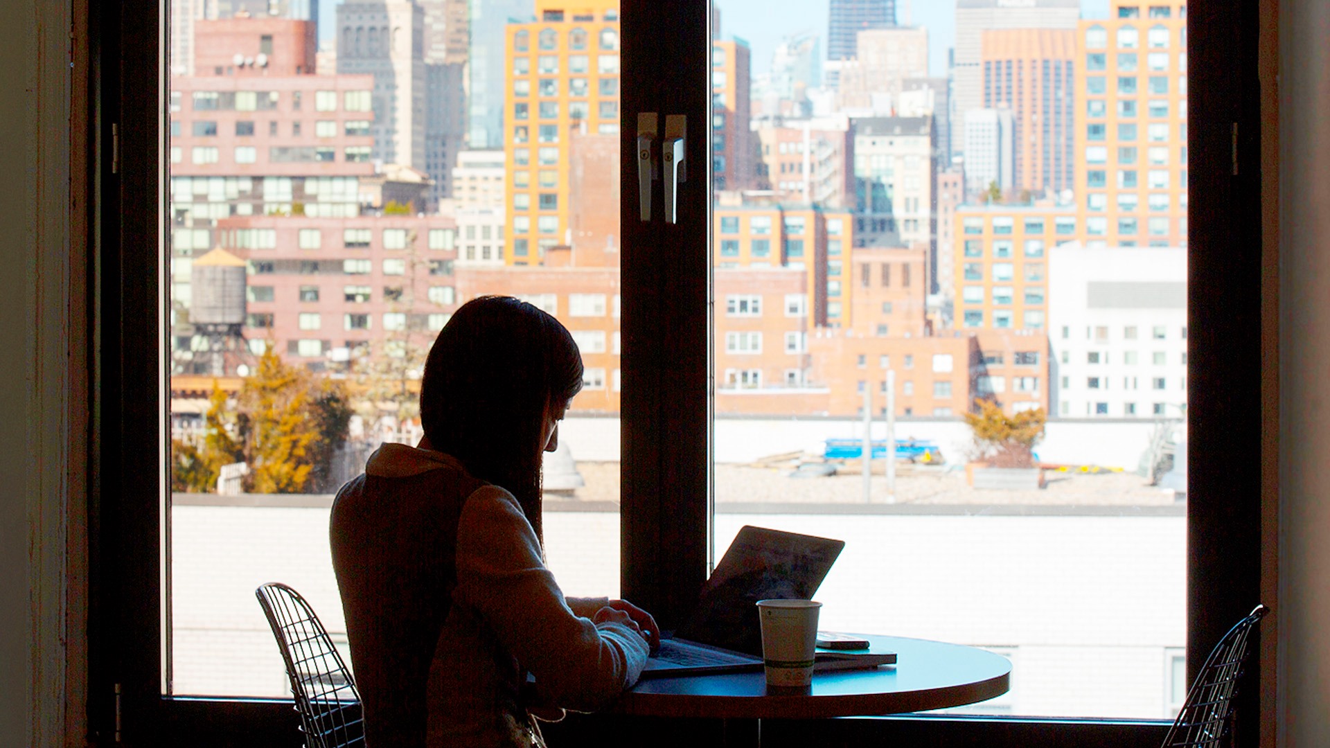 Photo of a woman working on a laptop