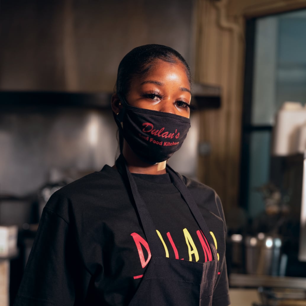 Woman wearing mask at Dulan's Soul Food Kitchen, Inglewood, Los Angeles.