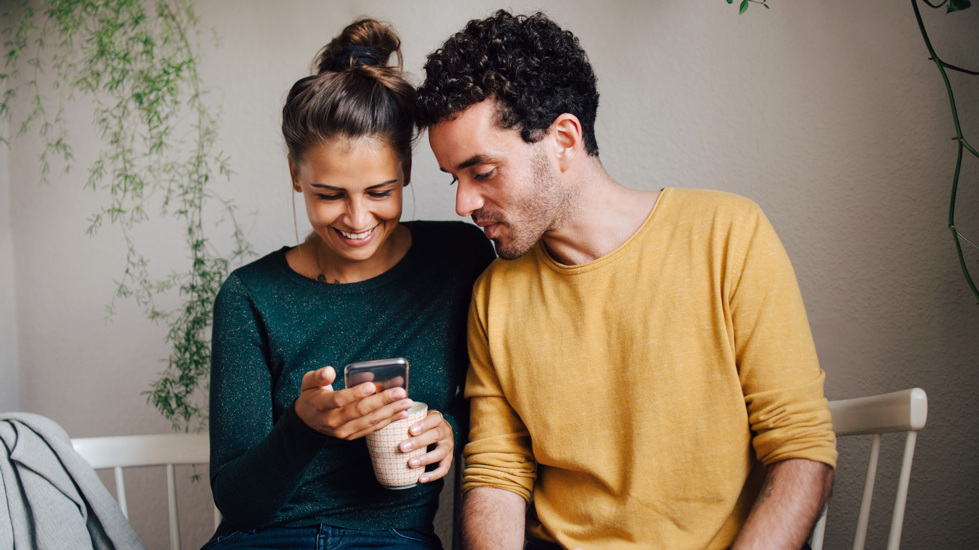 Photo of a man and a woman looking at a phone screen