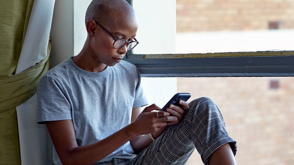 Photo of a woman reading on her phone