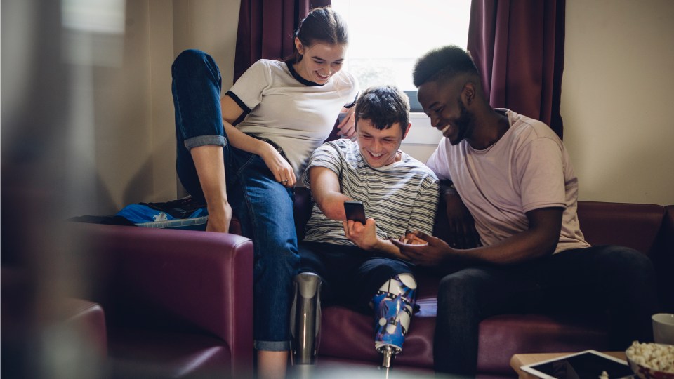 Image of people playing Facebook Fantasy Games on their phones