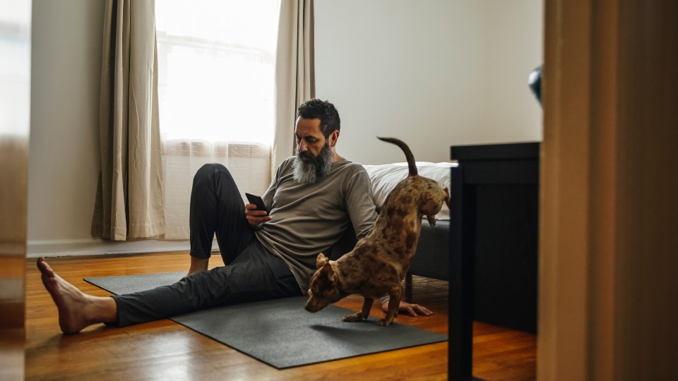 Photo of a man scrolling on his phone