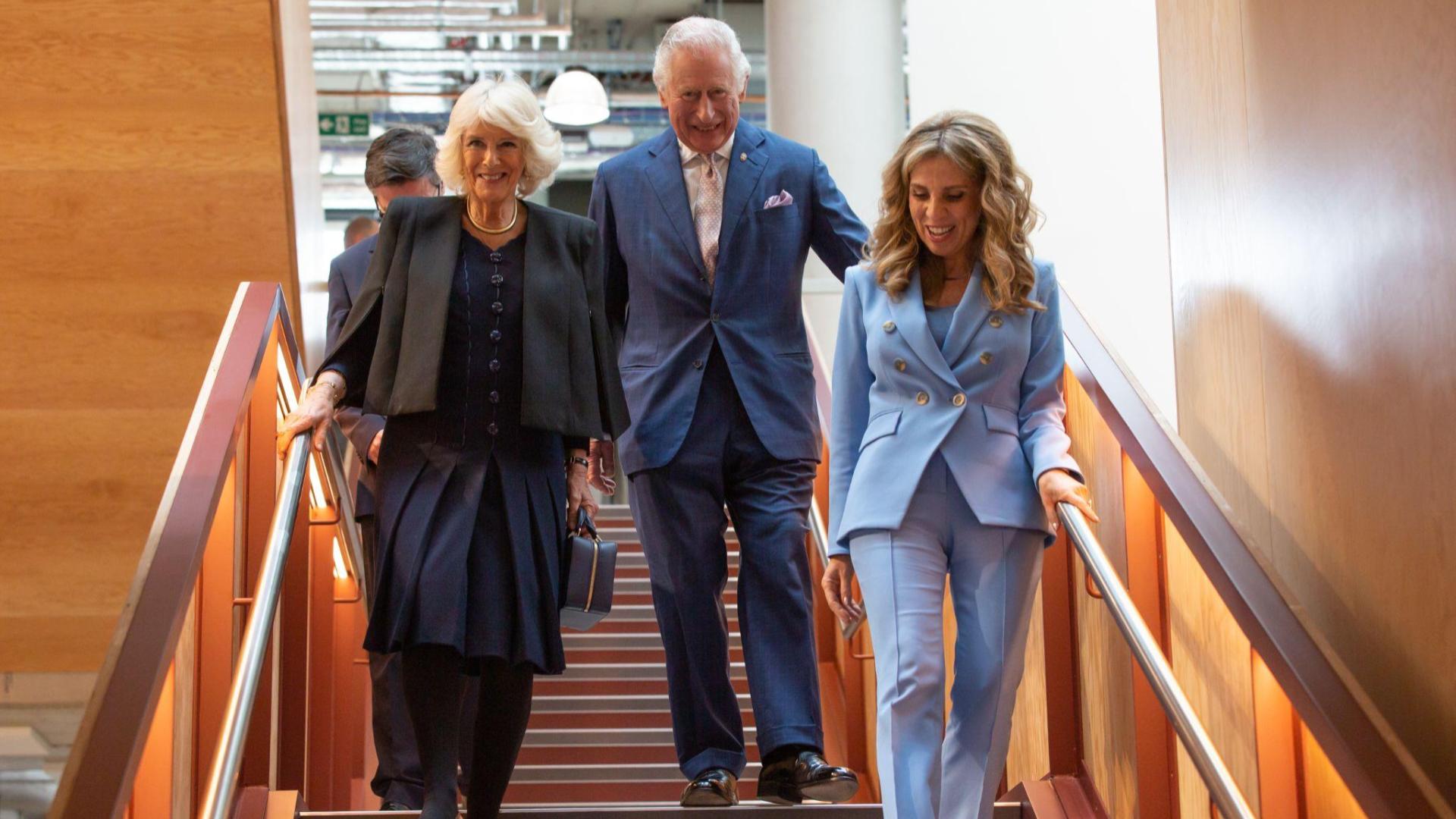 Their Royal Highnesses The Prince of Wales and The Duchess of Cornwall walking down the stairs with Nicola Mendelsohn