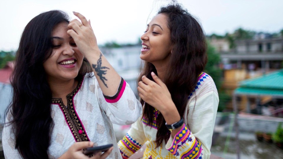 Two women laughing together