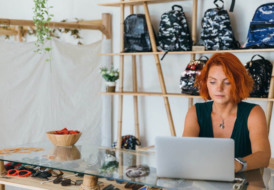 woman in retail shop on laptop