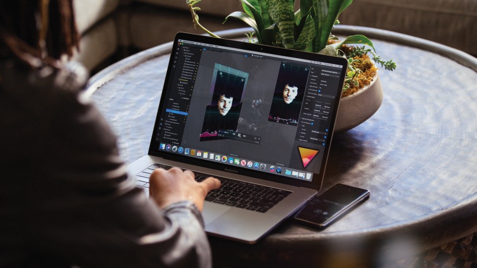 person creating an AR filter on a laptop
