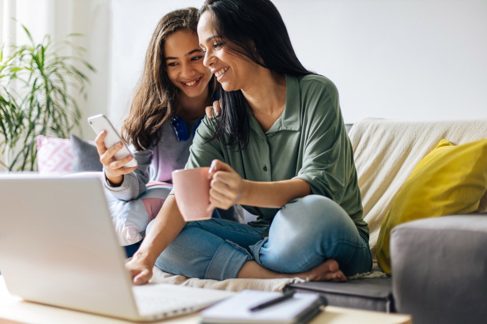 mother and daughter looking at a phone