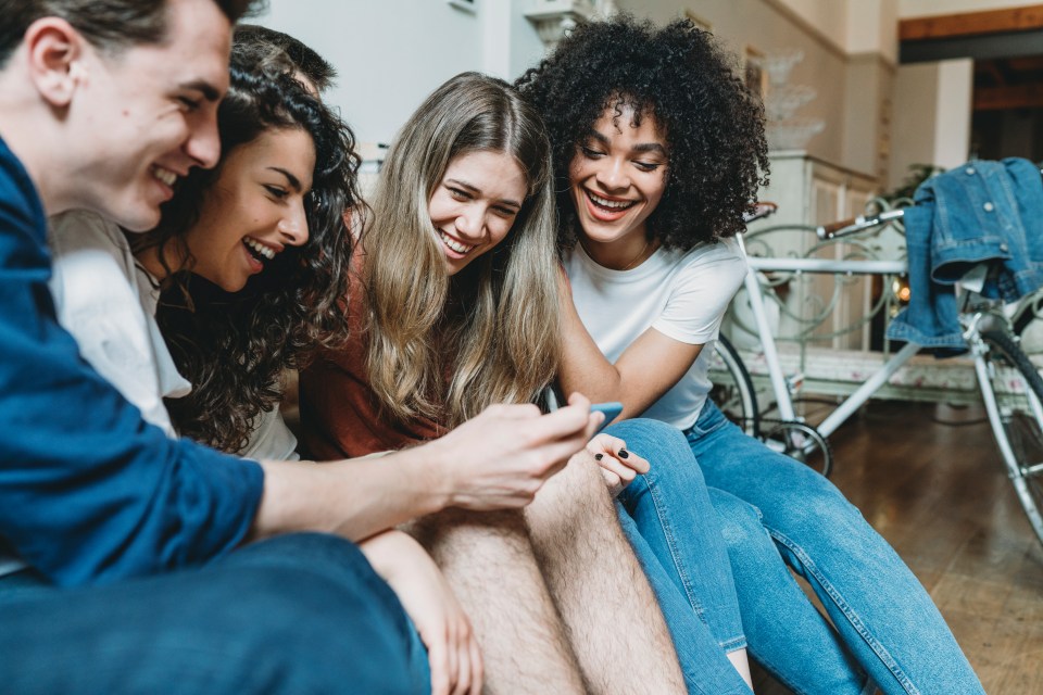 Friends looking at a mobile phone together