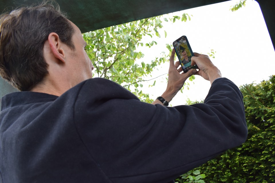 man using AR filter on front facing phone camera