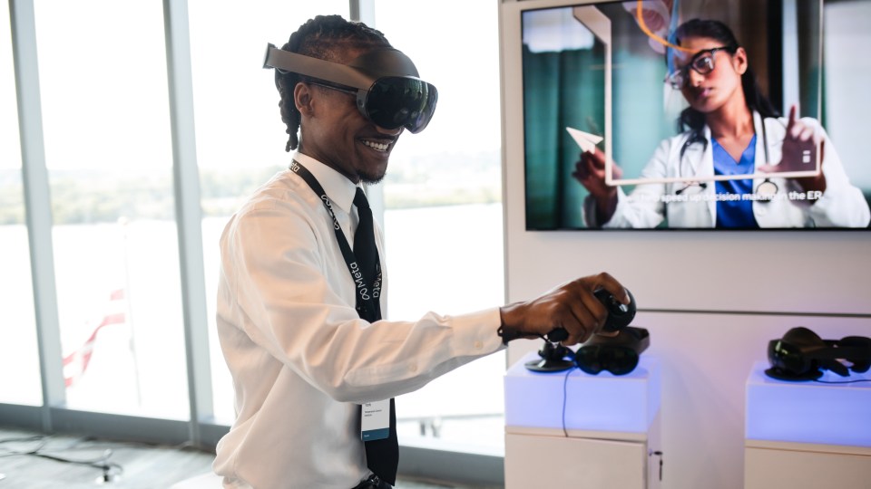 An image of a man at Meta's Future of Work Summit using a Meta Quest Pro VR device.