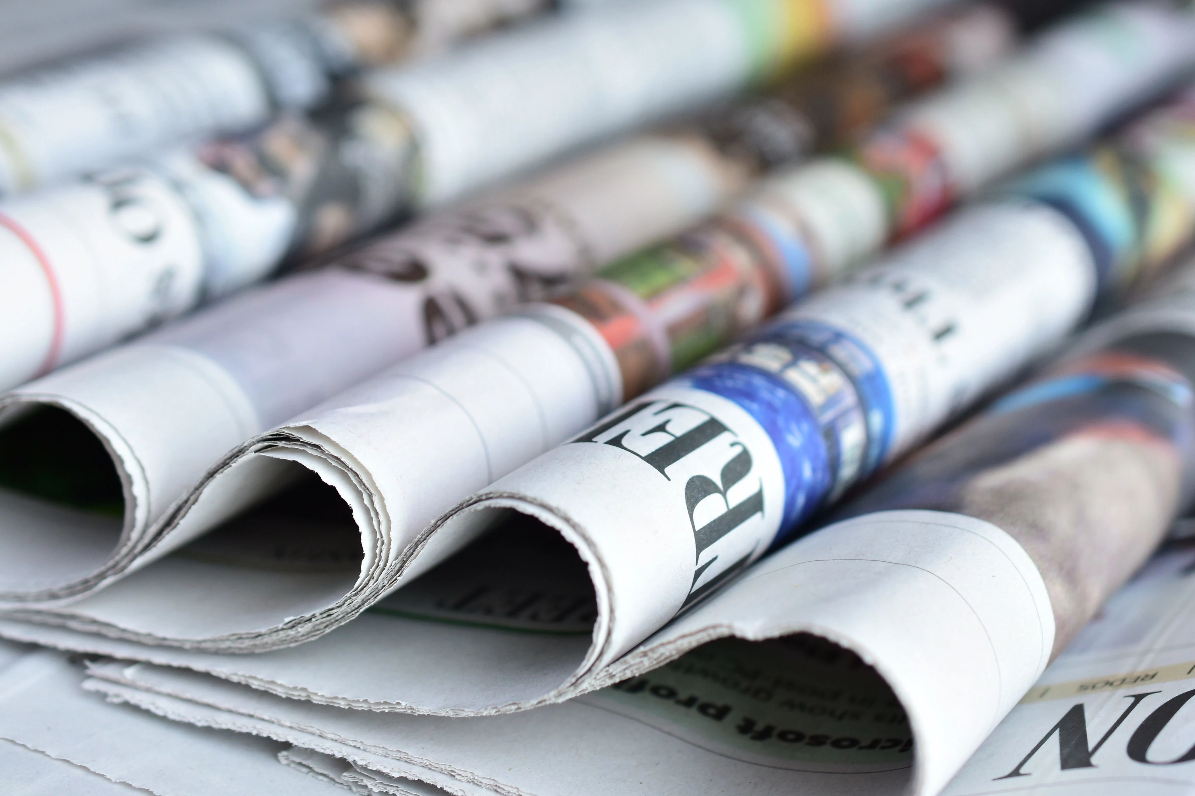 newspapers rolled up on a table