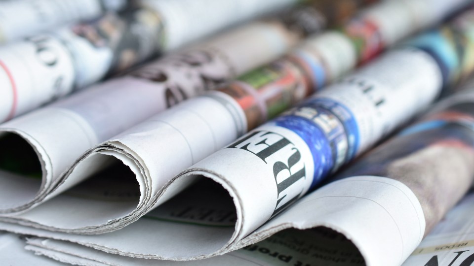 Images of newspapers stacked on top of each other.