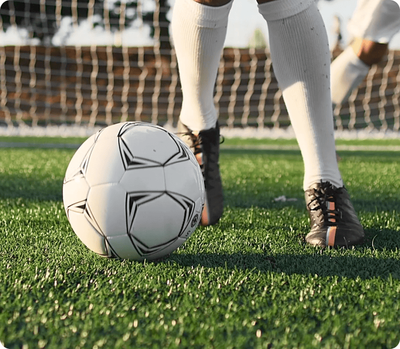 GIF of foot dribbling soccer ball, with SAM 2 highlighting and following the foot and ball as they move