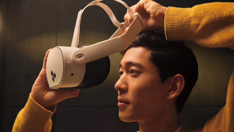 Image of a man putting on a Quest headset