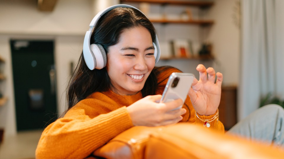 Woman wearing headphones on her phone
