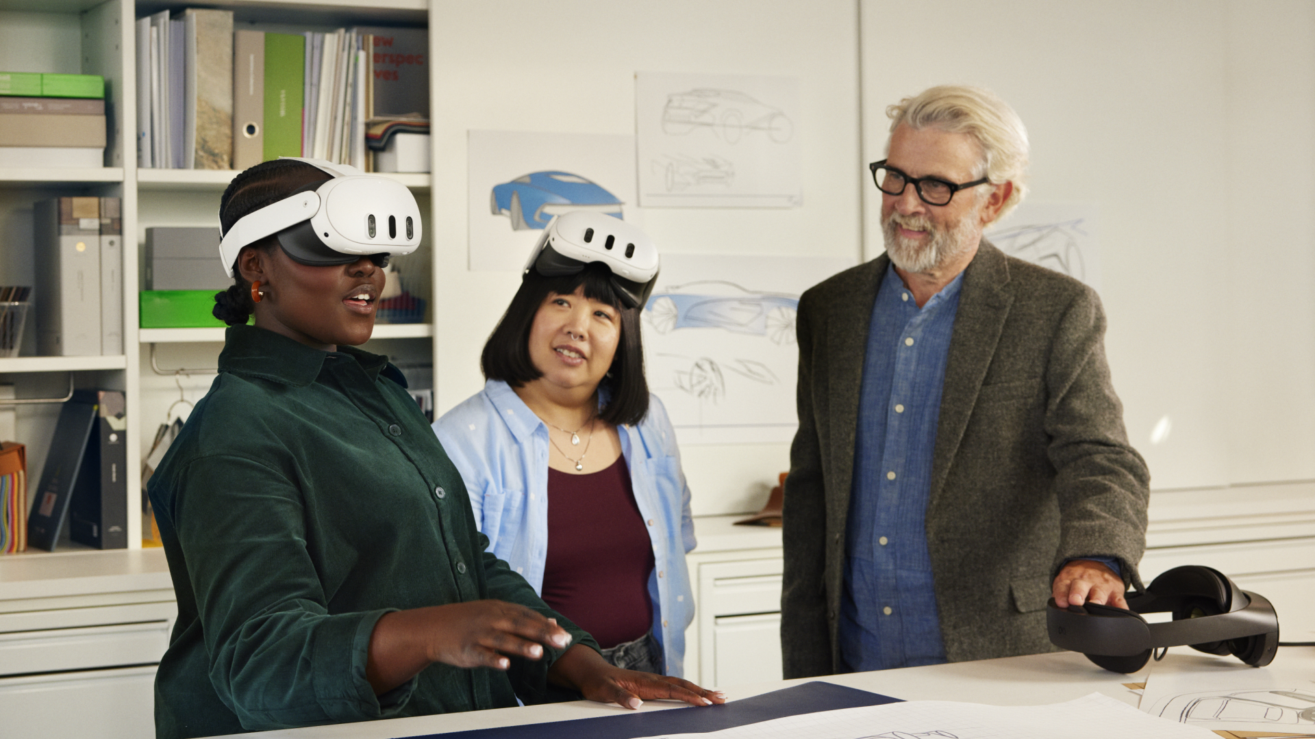 A photo of a professor looking on as his students use the Meta Quest headset.