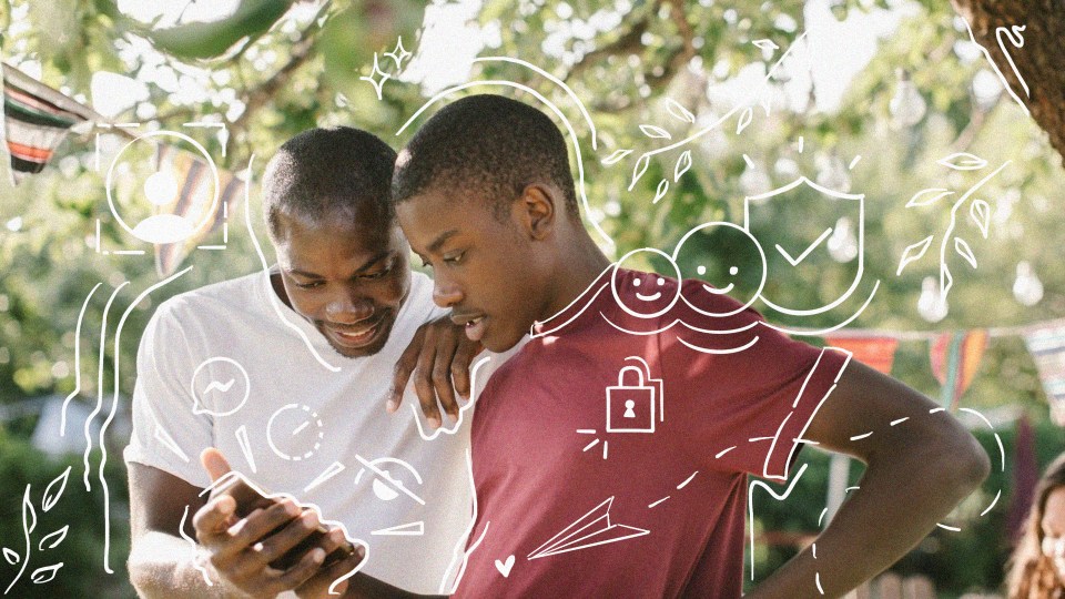 Photo of parent and child looking at a phone together