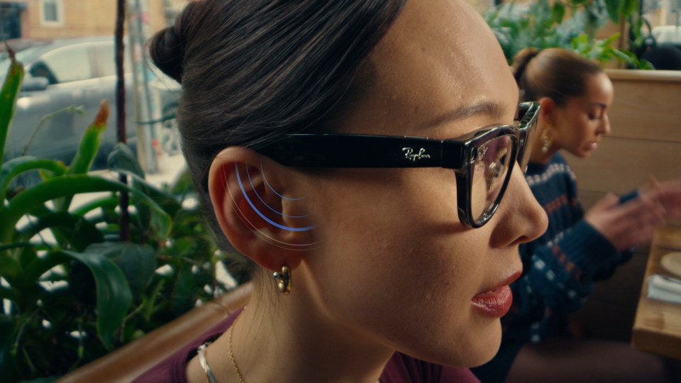 A photo of a woman wearing Ray-Ban Meta glasses using conversation focus