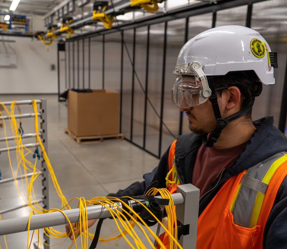 An image of a fiber technician working at a data center.