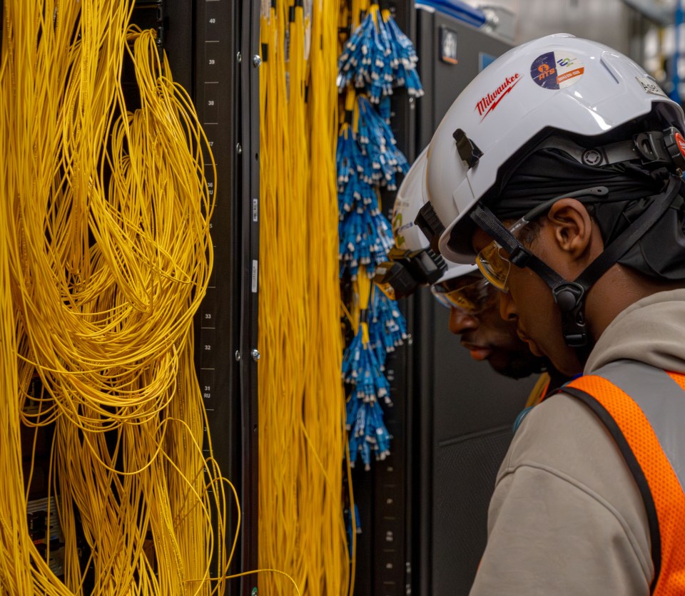 An image of a fiber technician working at a data center.