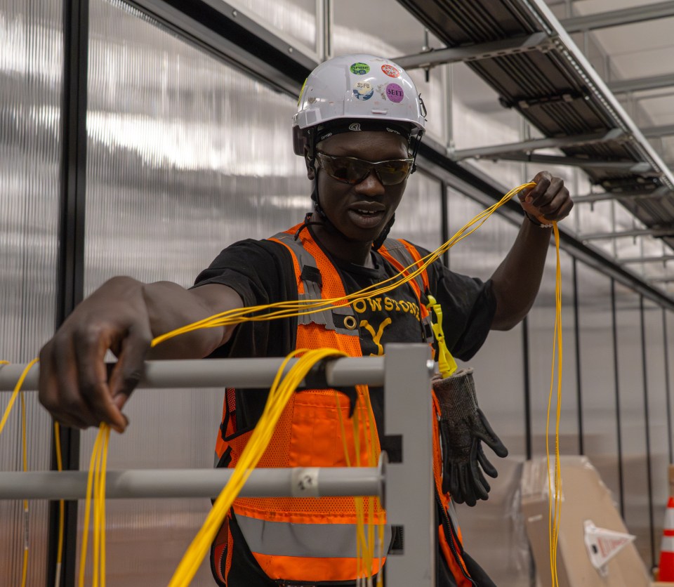 An image of a fiber technician working at a data center.