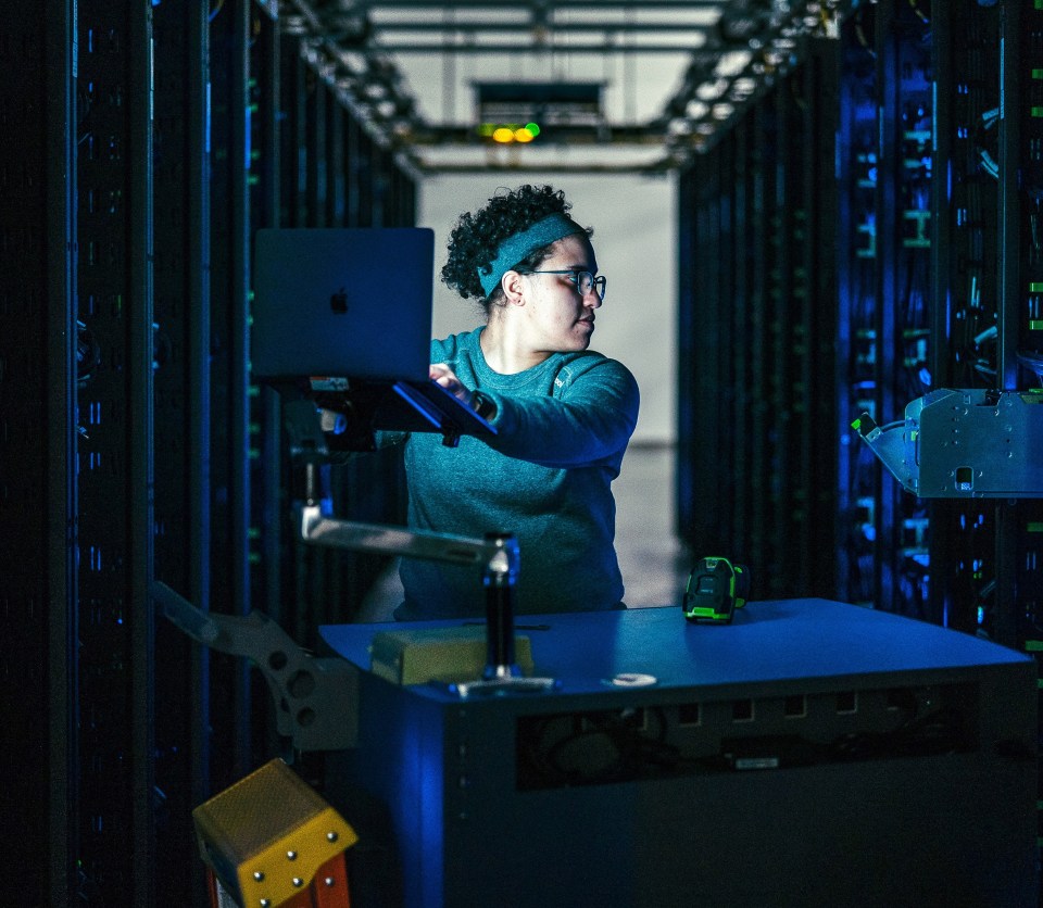 Photo of a person working in a data center